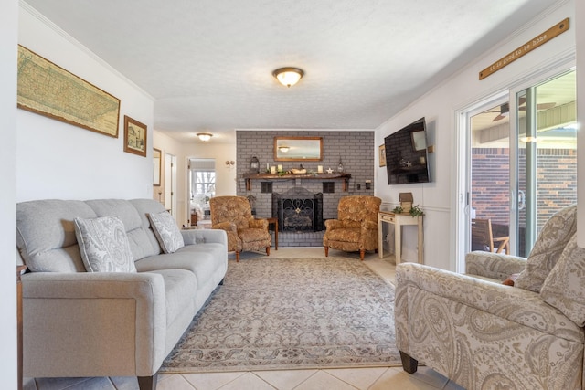 living room with a textured ceiling, a brick fireplace, tile patterned flooring, and crown molding