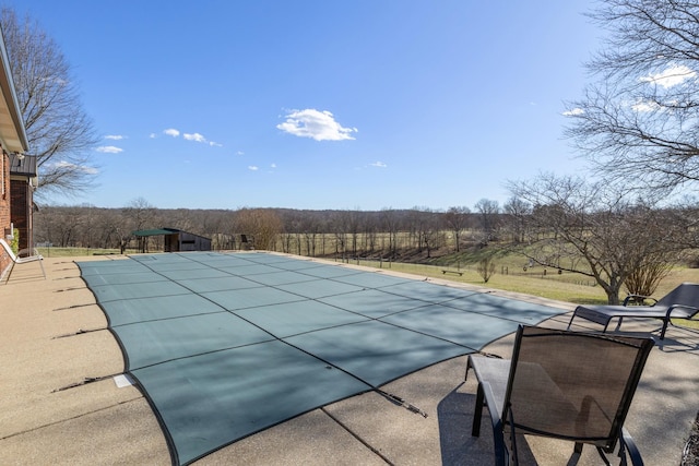 view of swimming pool with a patio and a covered pool