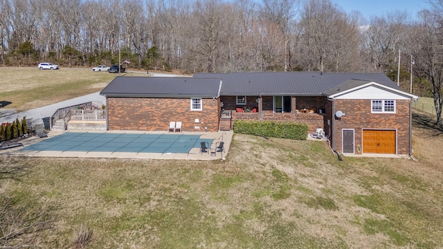 rear view of property with a patio area, a lawn, and brick siding