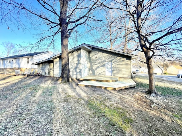 view of property exterior featuring a wooden deck