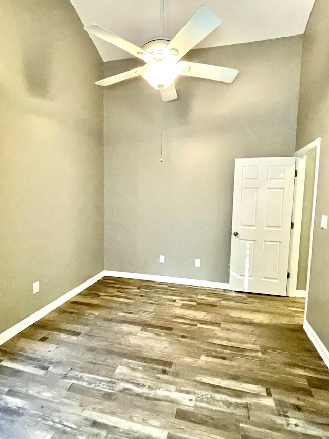 unfurnished room with a ceiling fan, baseboards, and wood finished floors