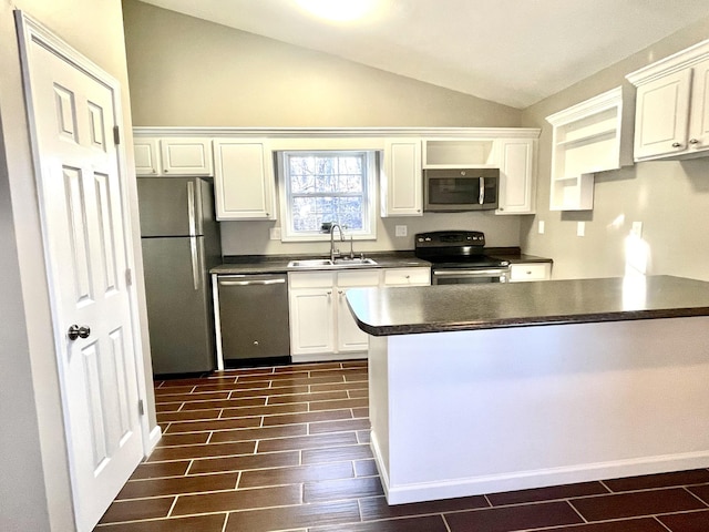 kitchen featuring stainless steel appliances, dark countertops, wood tiled floor, vaulted ceiling, and a sink