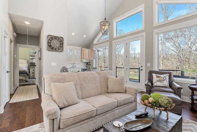 living room featuring attic access, high vaulted ceiling, wood finished floors, and recessed lighting