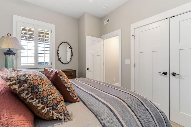 bedroom with a closet and visible vents