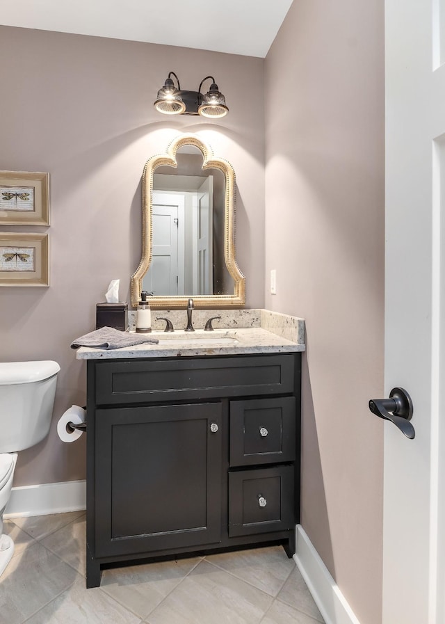 half bathroom featuring baseboards, vanity, and toilet