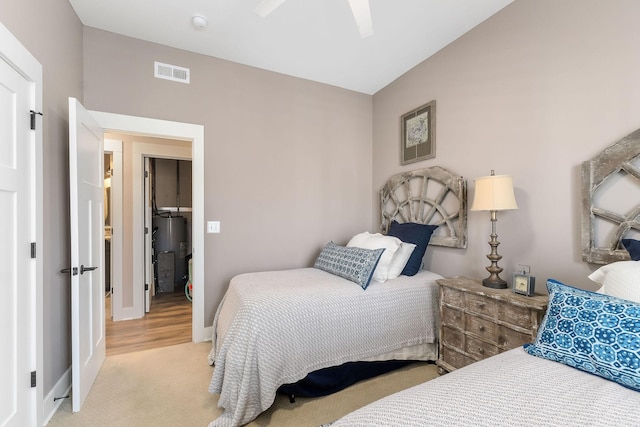 bedroom featuring visible vents, water heater, a ceiling fan, vaulted ceiling, and baseboards