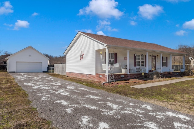 view of front facade featuring covered porch, a garage, an outdoor structure, fence, and crawl space