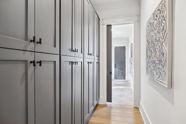 hallway featuring light wood-type flooring and baseboards