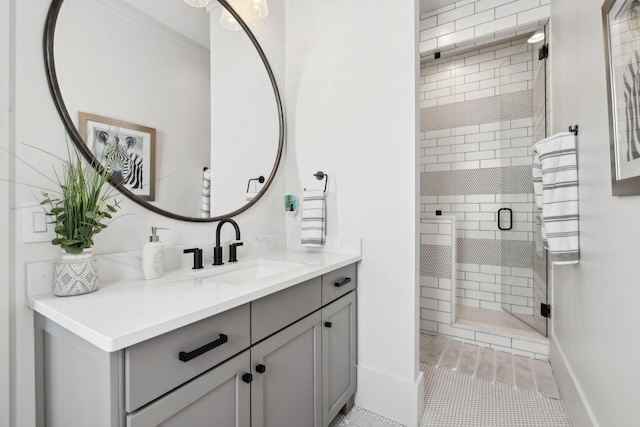 bathroom with a stall shower, vanity, and baseboards