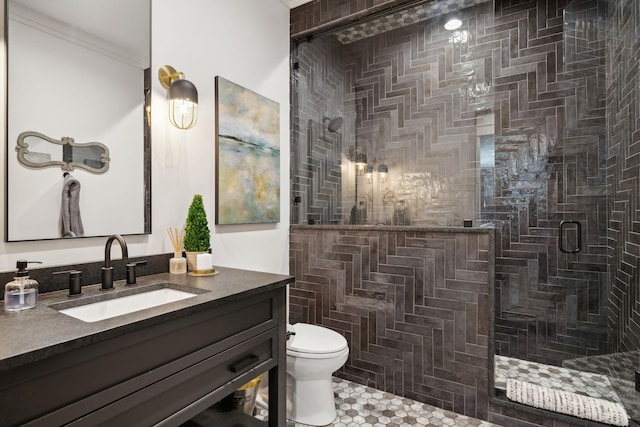 bathroom featuring toilet, a shower stall, crown molding, and vanity