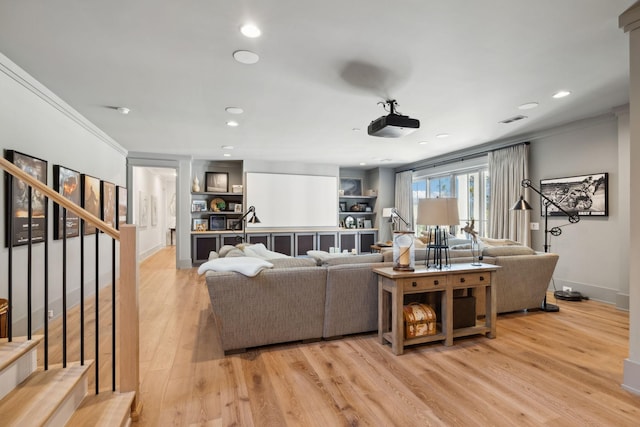 living room with recessed lighting, visible vents, stairs, ornamental molding, and light wood finished floors