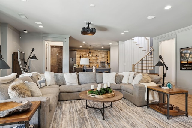 living room featuring stairs, light wood-style floors, and recessed lighting