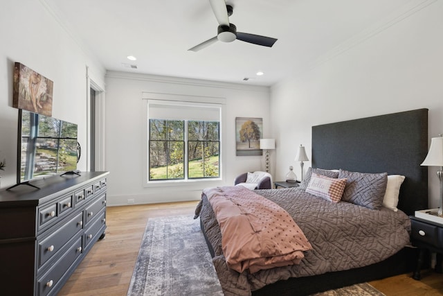 bedroom featuring visible vents, ornamental molding, light wood-style flooring, and recessed lighting