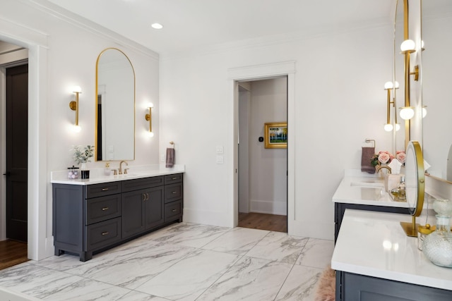 bathroom featuring marble finish floor, two vanities, a sink, and crown molding