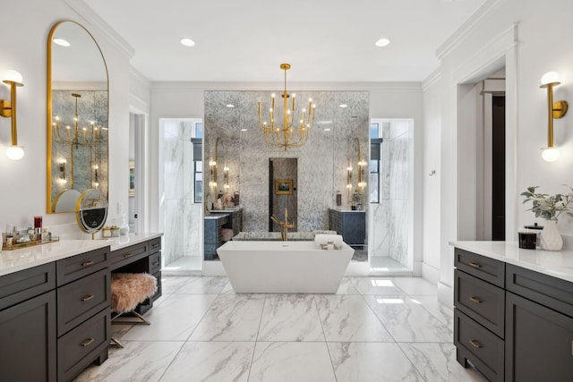 bathroom with marble finish floor, a notable chandelier, crown molding, and a soaking tub