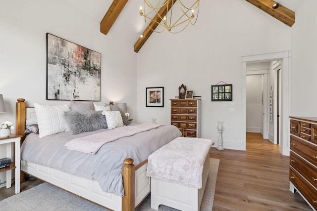 bedroom featuring high vaulted ceiling, beamed ceiling, and wood finished floors