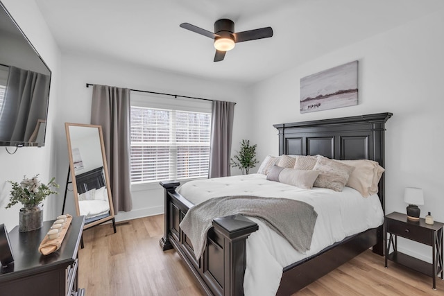 bedroom featuring baseboards, ceiling fan, and light wood finished floors