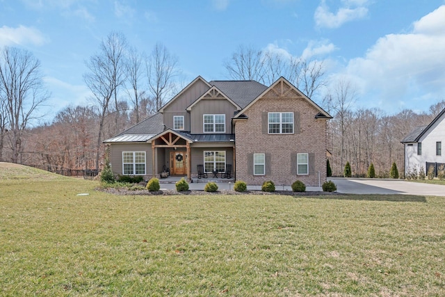 view of front facade with a porch, metal roof, a standing seam roof, a front lawn, and board and batten siding