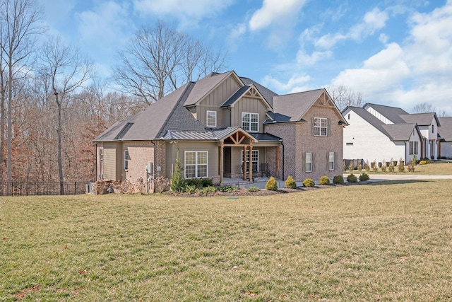 view of front of property featuring board and batten siding, a front yard, a standing seam roof, fence, and metal roof