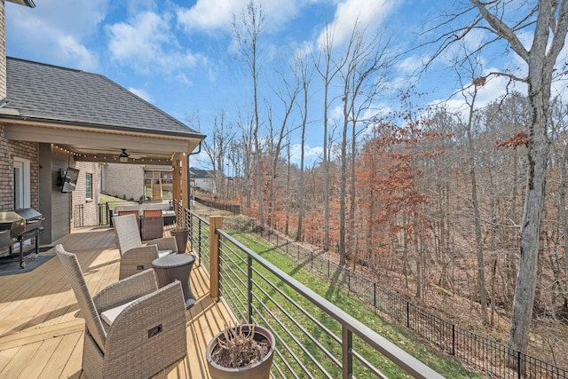 wooden terrace with ceiling fan and grilling area