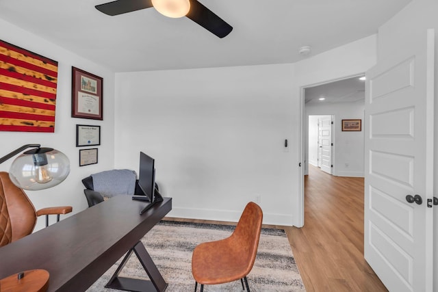 office featuring light wood-style floors, ceiling fan, and baseboards