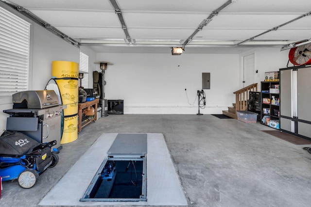 garage with electric panel and a garage door opener