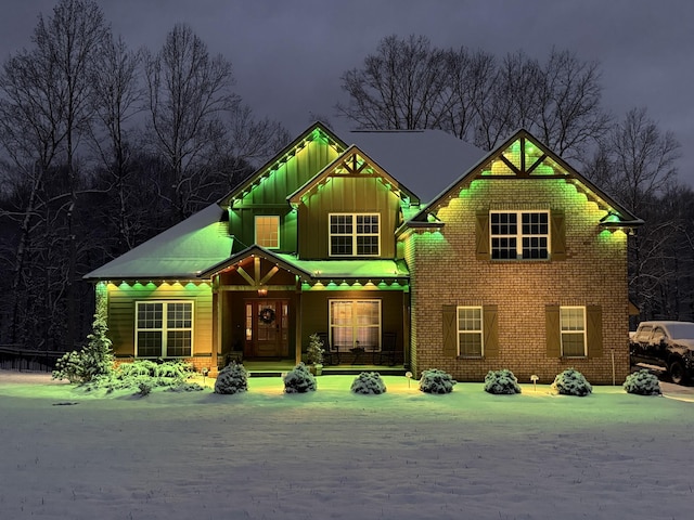 view of front of house featuring brick siding and board and batten siding