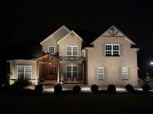 view of front of property with board and batten siding and brick siding