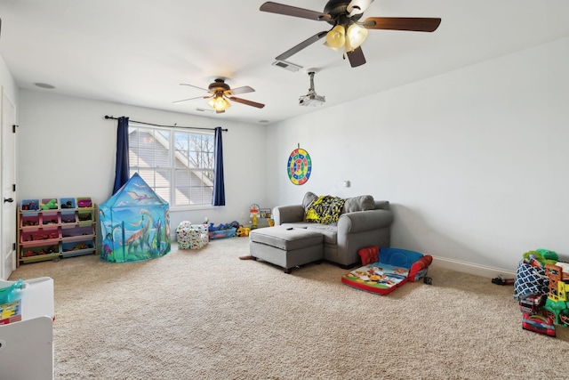 rec room with a ceiling fan, carpet, visible vents, and baseboards