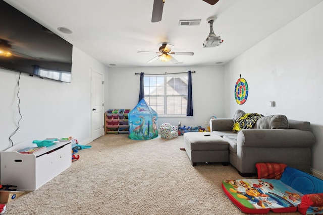 playroom with a ceiling fan, carpet, and visible vents