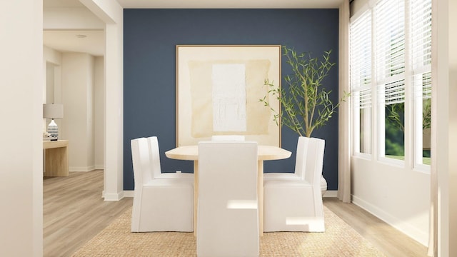 dining room featuring light wood-style flooring and baseboards