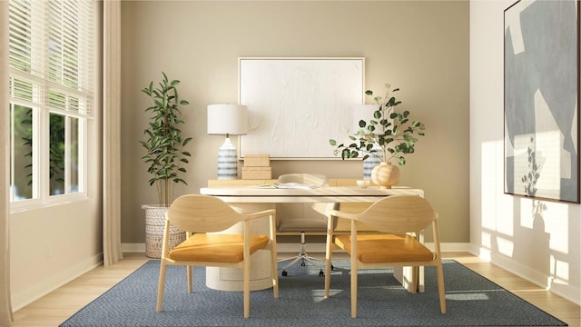 office area with light wood finished floors and baseboards