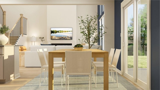 dining room featuring stairway, plenty of natural light, and light wood-style flooring