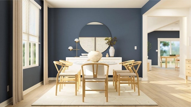 dining area featuring wood finished floors and baseboards