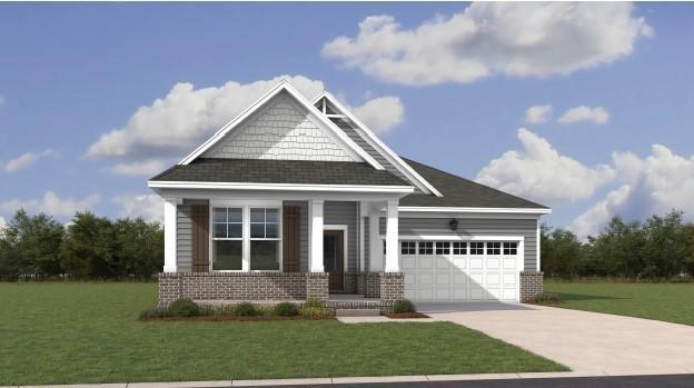 craftsman house with an attached garage, brick siding, concrete driveway, and a front yard