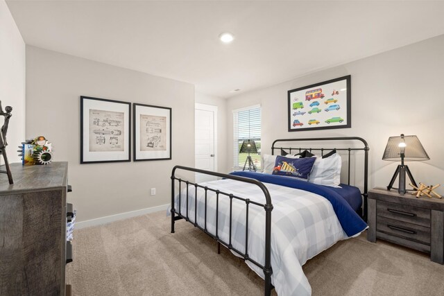 carpeted bedroom featuring baseboards