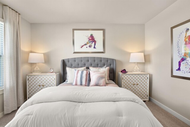 bedroom featuring carpet floors and baseboards