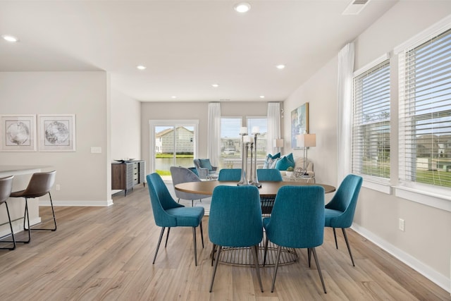 dining area featuring recessed lighting, light wood-style flooring, and baseboards