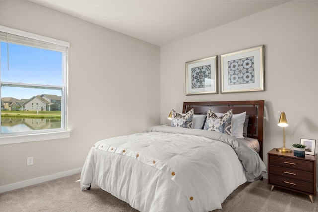 carpeted bedroom featuring baseboards