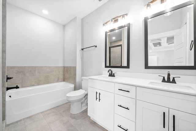 bathroom featuring tile patterned flooring, a sink, toilet, and double vanity