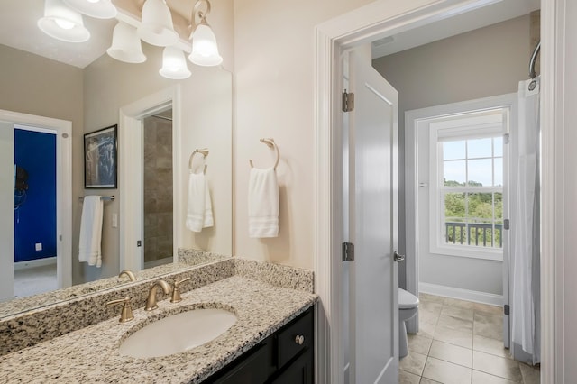 full bath featuring tile patterned flooring, baseboards, a notable chandelier, and vanity