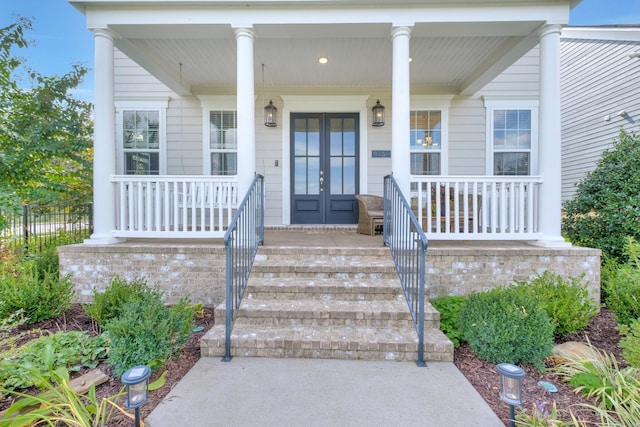 property entrance with a porch and french doors