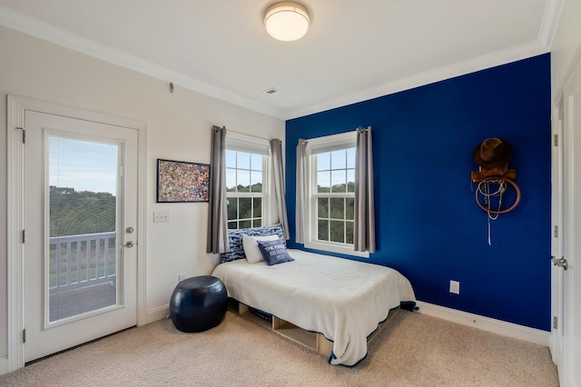 carpeted bedroom featuring baseboards, ornamental molding, and access to exterior