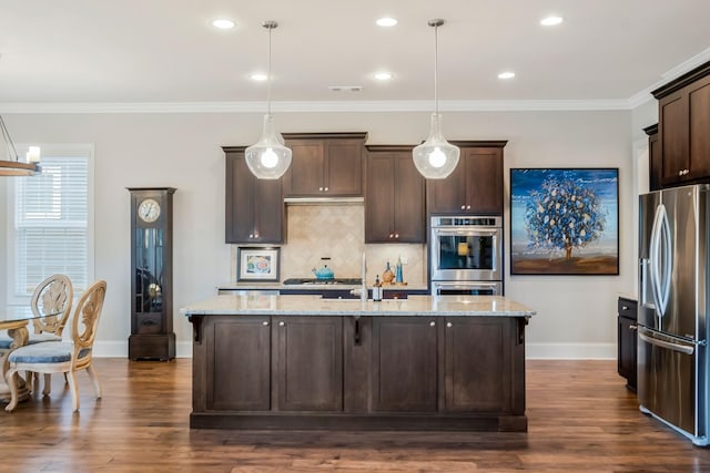 kitchen with appliances with stainless steel finishes, dark wood-style flooring, dark brown cabinetry, and tasteful backsplash