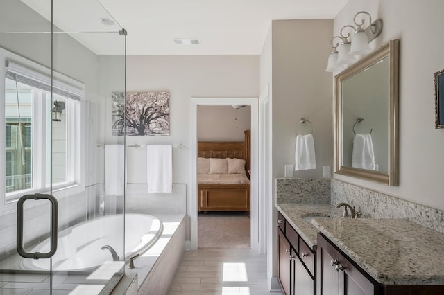 full bath with a garden tub, connected bathroom, visible vents, and vanity