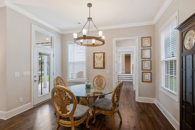 dining space featuring dark wood-style floors, baseboards, and crown molding