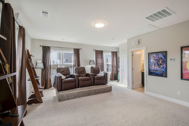 home theater featuring baseboards, visible vents, and light colored carpet