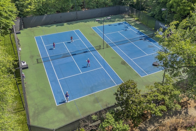 view of sport court featuring fence