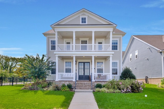 neoclassical / greek revival house featuring french doors, covered porch, a balcony, and a front lawn