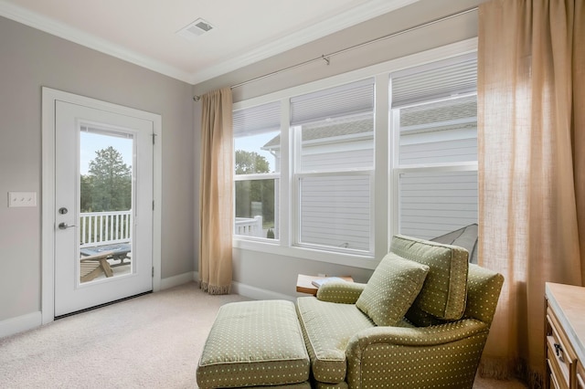 sitting room with ornamental molding, carpet flooring, visible vents, and baseboards